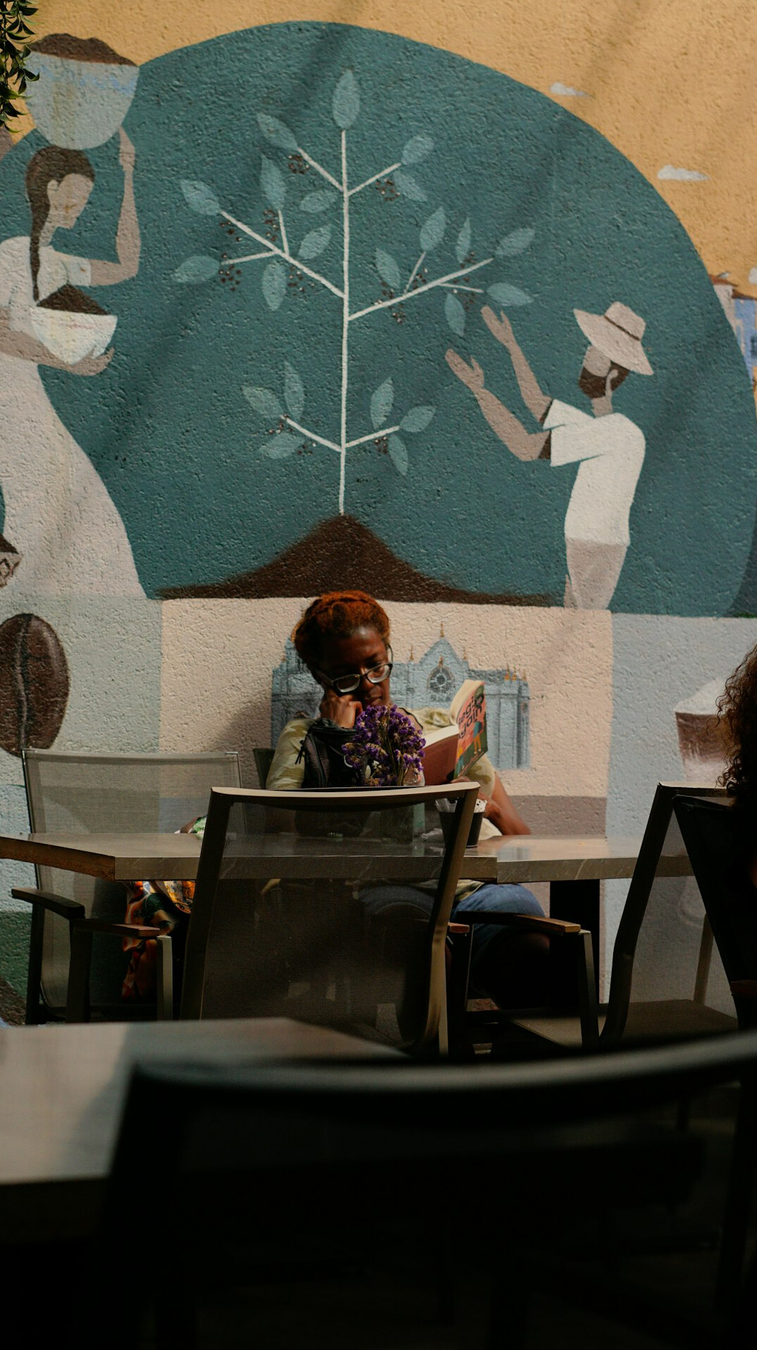 person reading book in cafe